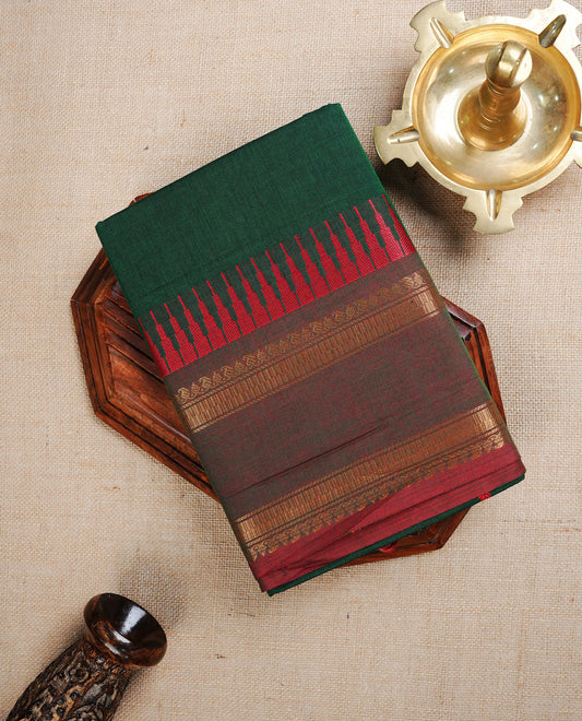 Bottle  Green  colour chettinad cotton saree featuring A Plain  body, complemented by Contrast  Red Colour With Gold Zari border, paired with matching blouse piece.