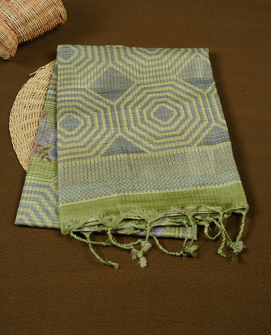 Leaf green colour semi tussar silk saree, featuring subtle hexagonal geometric patterns across the body, a textured pallu with fine detailing, and finished with a matching blouse.