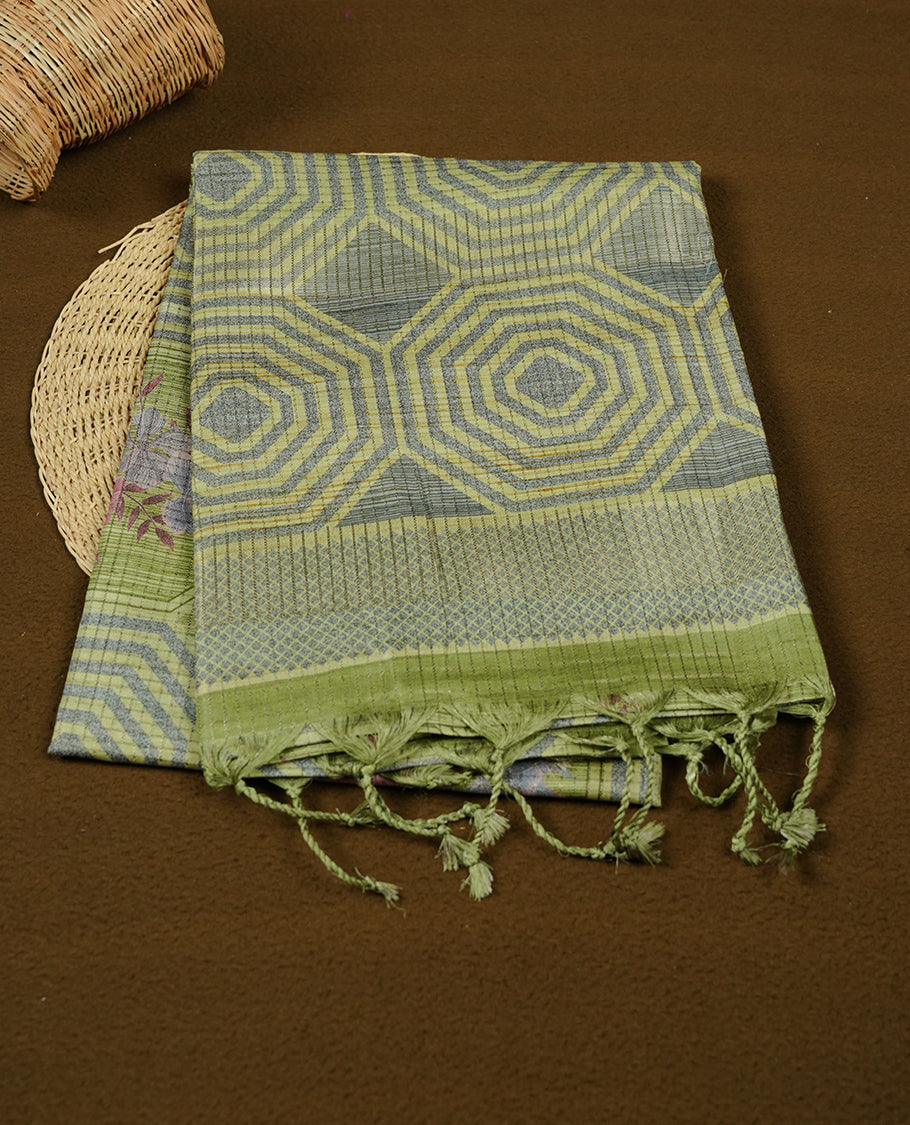 Leaf green colour semi tussar silk saree, featuring subtle hexagonal geometric patterns across the body, a textured pallu with fine detailing, and finished with a matching blouse.