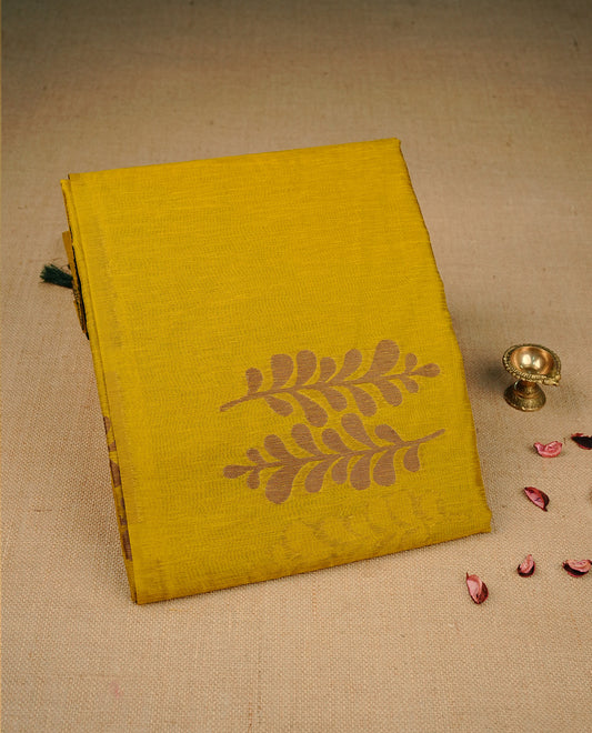 Mustard yellow colour semi linen saree with elegant gold zari Leaf motifs across the body, complemented by a contrast forest Green colour with grand gold zari pallu and a borderless design, paired with a matching blouse piece.