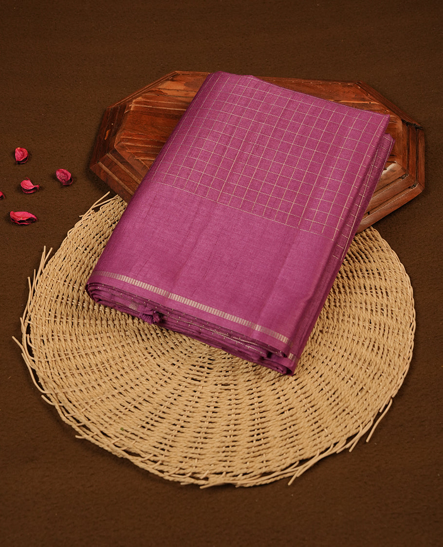 Pastel grape colour semi Tussar saree highlights gold zari check pattern across body,  border, pallu and paired with matching blouse piece.