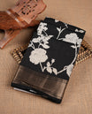 Black colour Viscos semi printed saree featuring a light golden zari border, abstract off white printed motifs on the body, and comes with a matching blouse