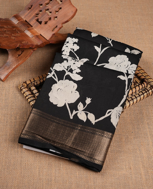 Black colour Viscos semi printed saree featuring a light golden zari border, abstract off white printed motifs on the body, and comes with a matching blouse