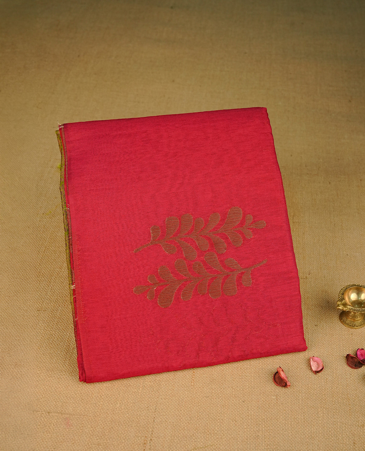 Dark Red colour semi linen saree with elegant gold zari Leaf motifs across the body, complemented by a contrast green colour with grand gold zari pallu and a borderless design, paired with a matching blouse piece.