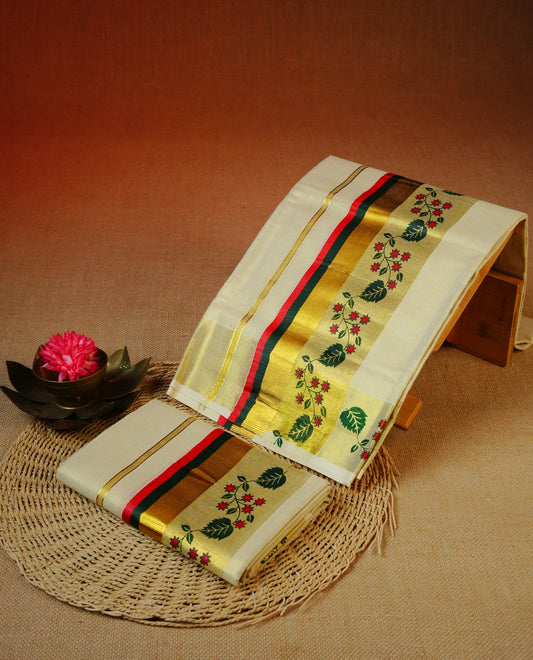 Cream Colour tissue set mundu featuring a plain body, enhanced with delicate red floral vine motifs & Red, Green & a gold zari kara.
