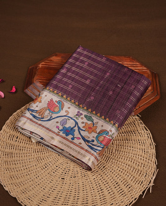Maroon colour semi tusser silk saree featuring gold zari check pattern with floral butti motifs, with contrast floral kodi & bird pattern and paired with matching blouse.