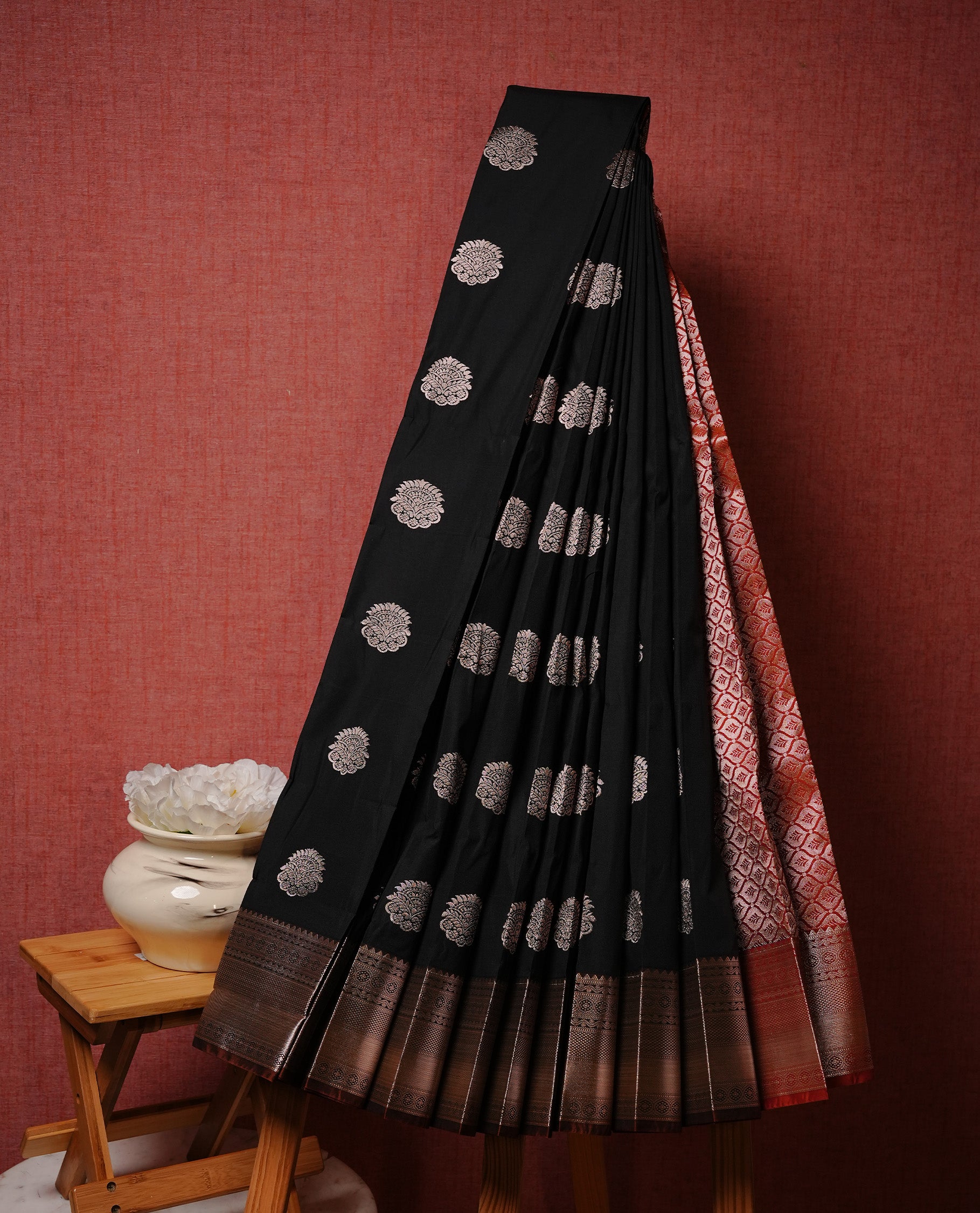 Black colour Semi silk saree Featuring gold zari motifs on body, complemented by Contrast brown colour with gold zari border, paired with matching blouse piece.