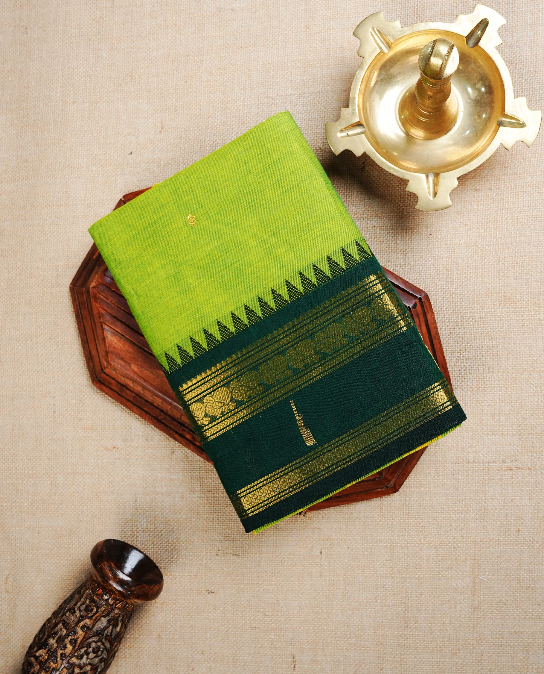 Light Green  colour chettinad cotton saree featuring  Gold Motifs  on body, complemented by Contrast  Forest Green Colour With Gold Zari border, paired with matching blouse piece.