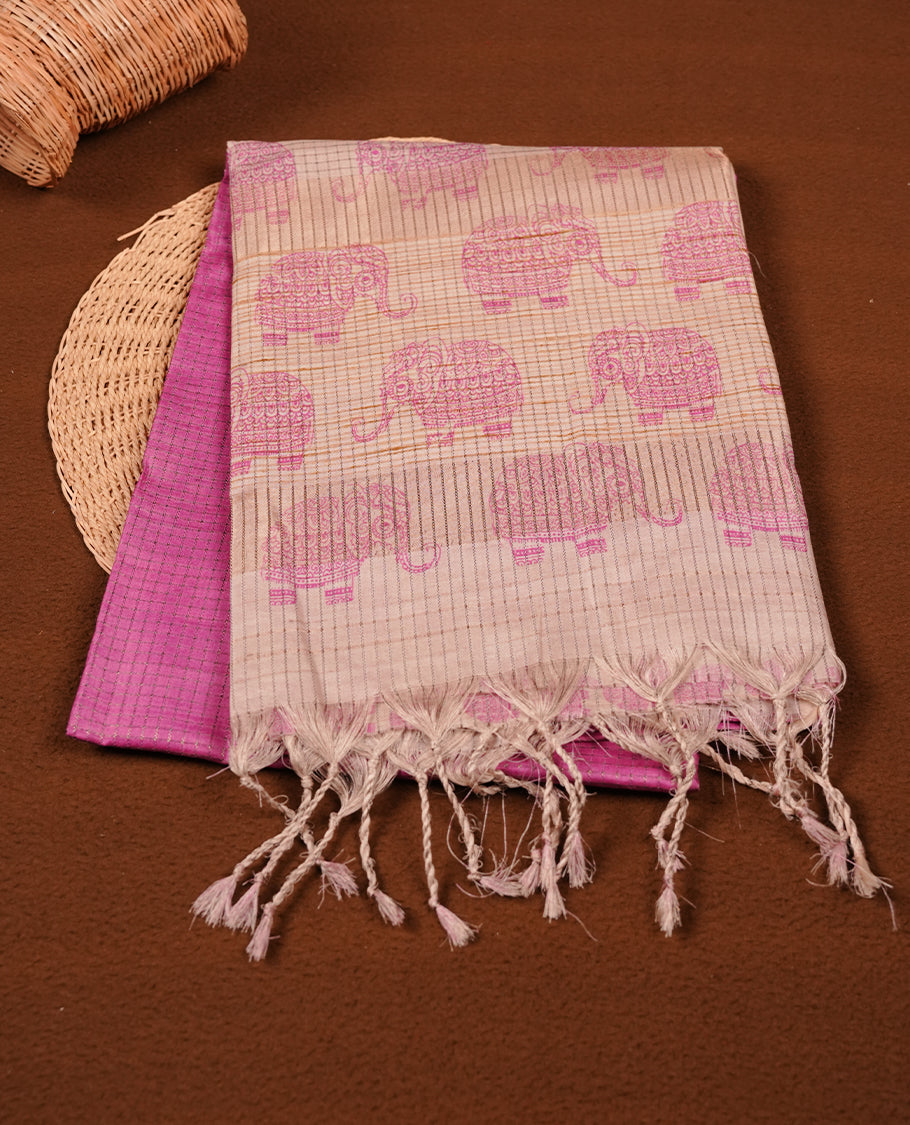 Pink colour semi tussar silk saree featuring an all-over elephant motif print across the body, complemented by a contrasting yellow pallu and border, and paired with a matching blouse piece.