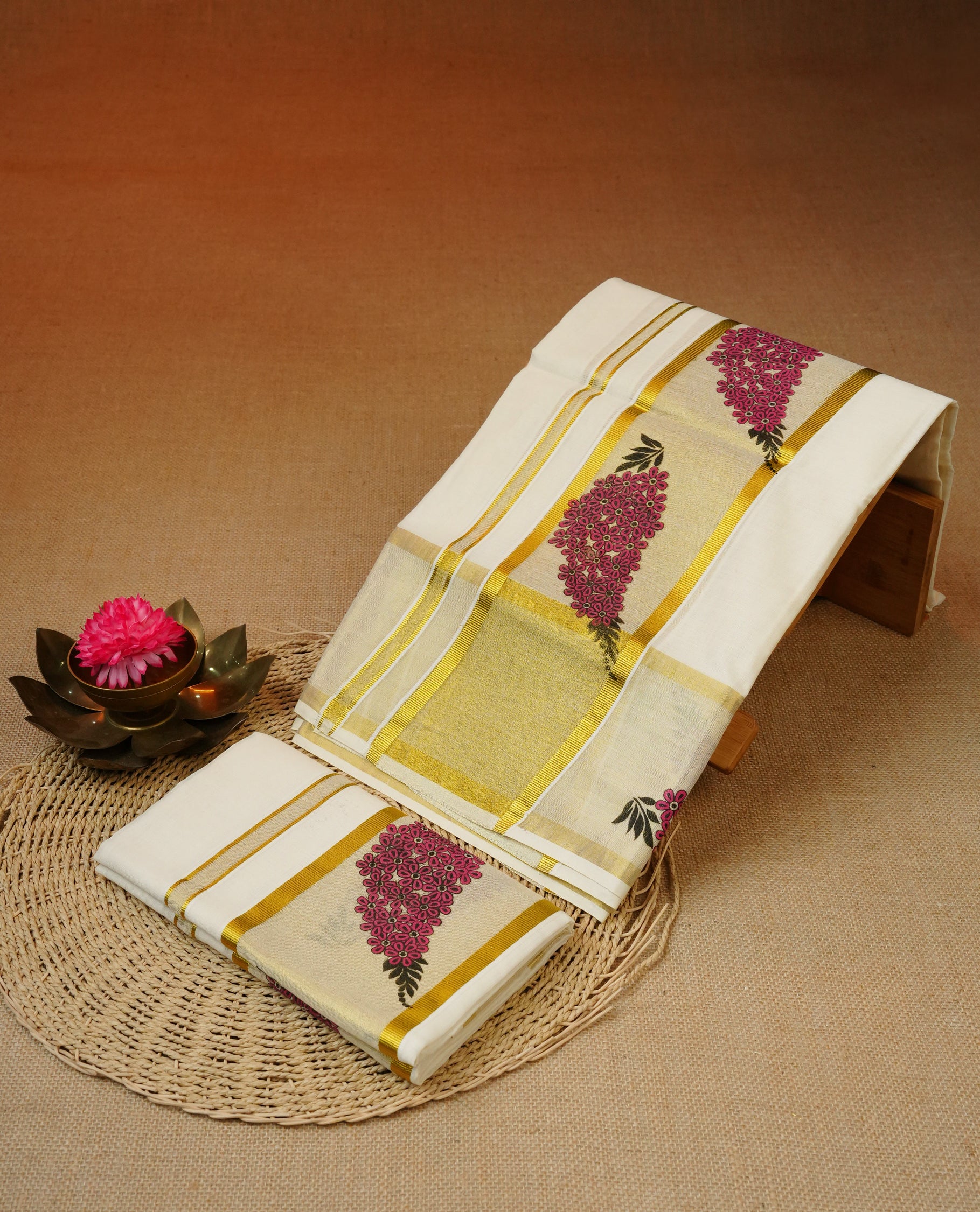 Cream colour cotton set mundu featuring gold kasav kara with floral print.