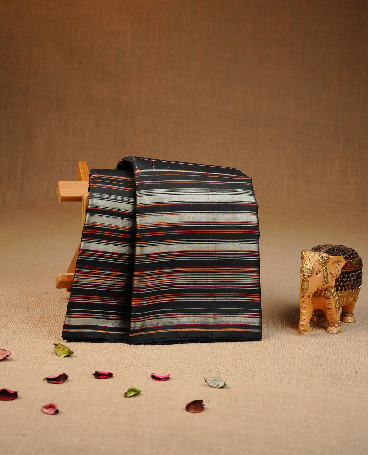 Black colour traditional kancheepuram silk saree featuring Check pattern on body, complemented by self colour with Strip border, comes with matching blouse piece.