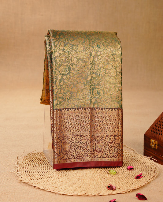 Green & Gold colour Double shade Semi tissue silk saree featuring Gold zari Floral pattern on body, Contrast Chocolate colour with Fancy border, paired with matching.