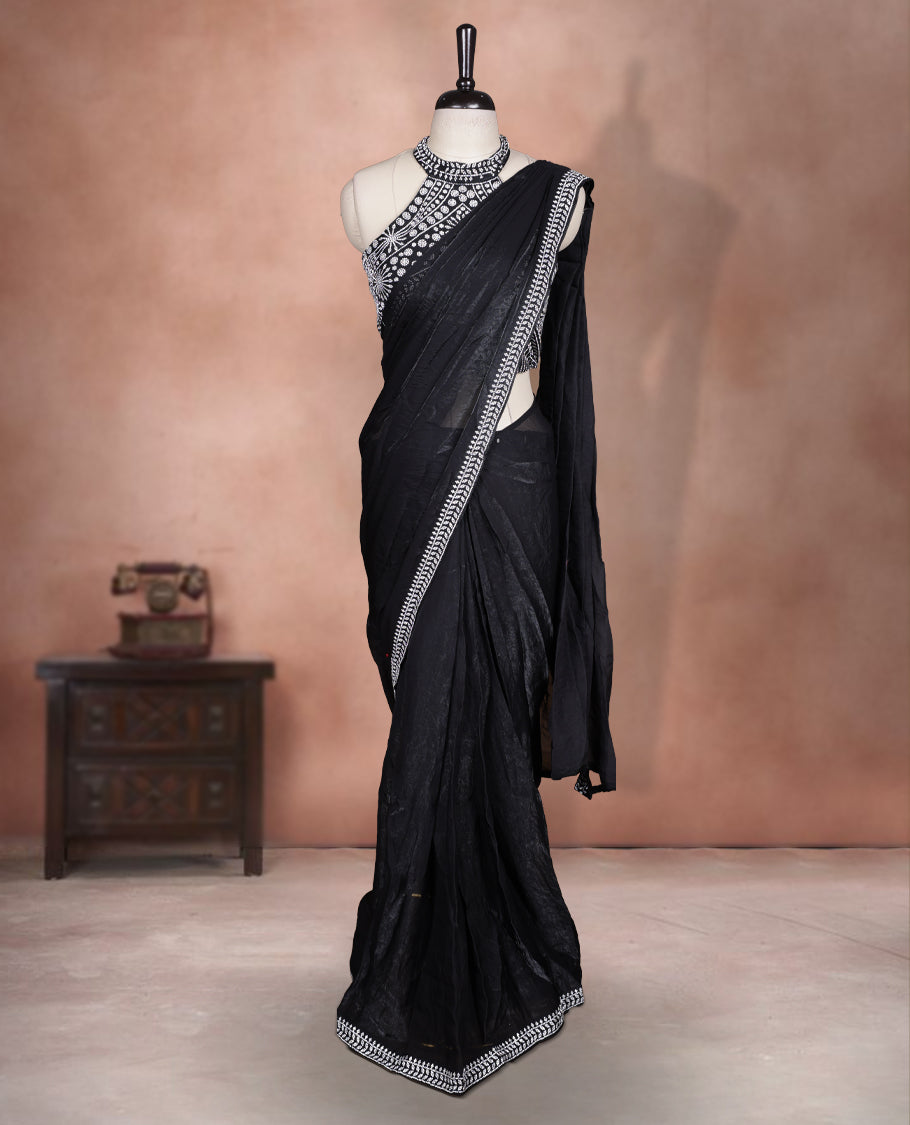 Elegant Black colour ready to wear saree adorned with rich silver stone embroidery along the border and pallu, paired with a heavily embellished matching blouse for a grand festive look.