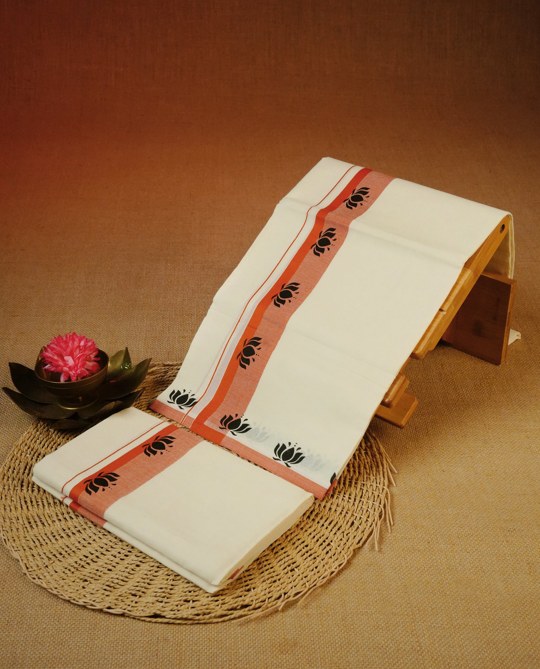 Cream colour cotton Set Mundu With Plain body, enhanced with Orange colour kara with lotus print.