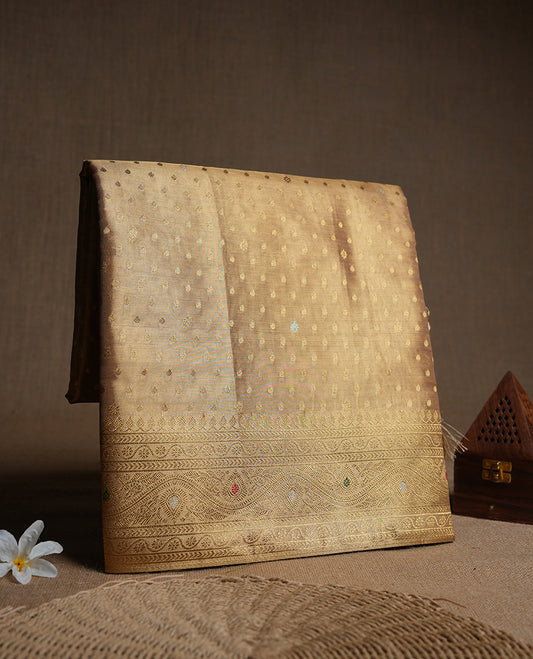 Light Gold colour tissue banaras silk saree featuring antique gold zari motifs on the body with rich traditional zari border and pallu, paired with a matching blouse piece.