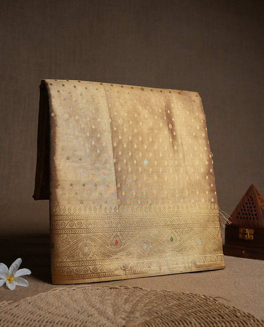 Light Gold colour tissue banaras silk saree featuring antique gold zari motifs on the body with rich traditional zari border and pallu, paired with a matching blouse piece.