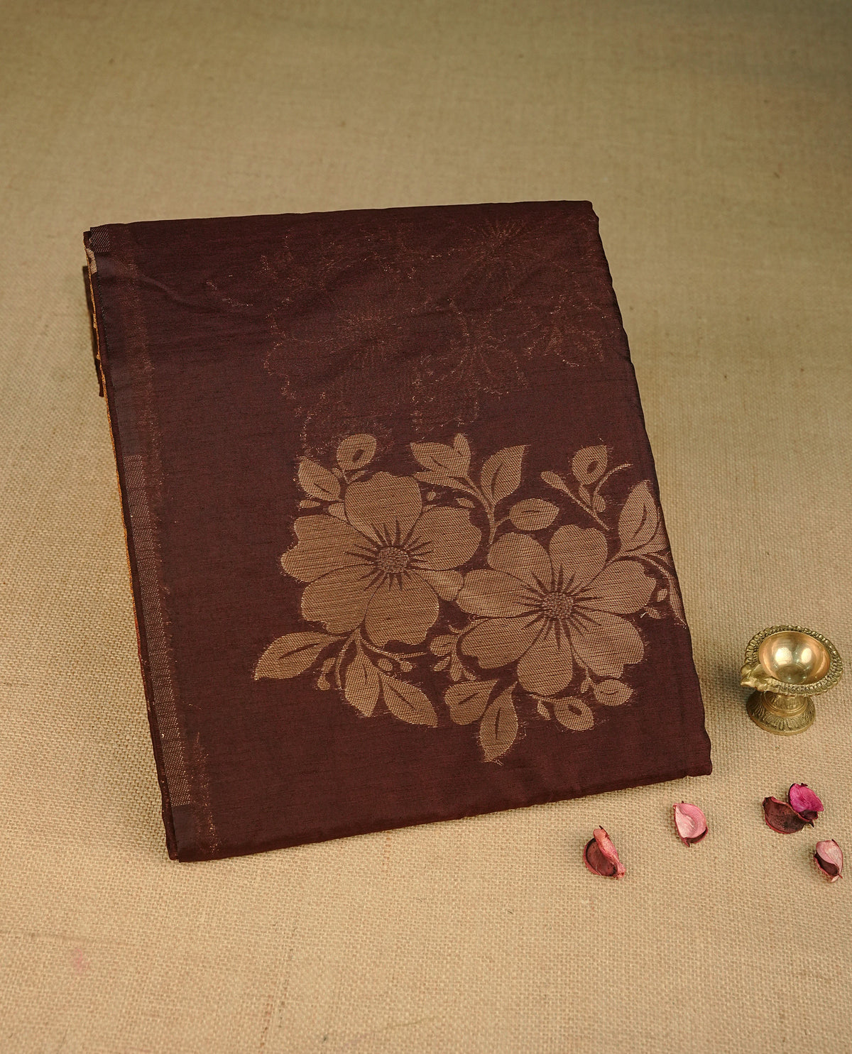 Chocolate brown colour semi linen saree with elegant gold zari floral motifs across the body, complemented by a contrast colour with grand gold zari pallu and a borderless design, paired with a matching blouse piece.