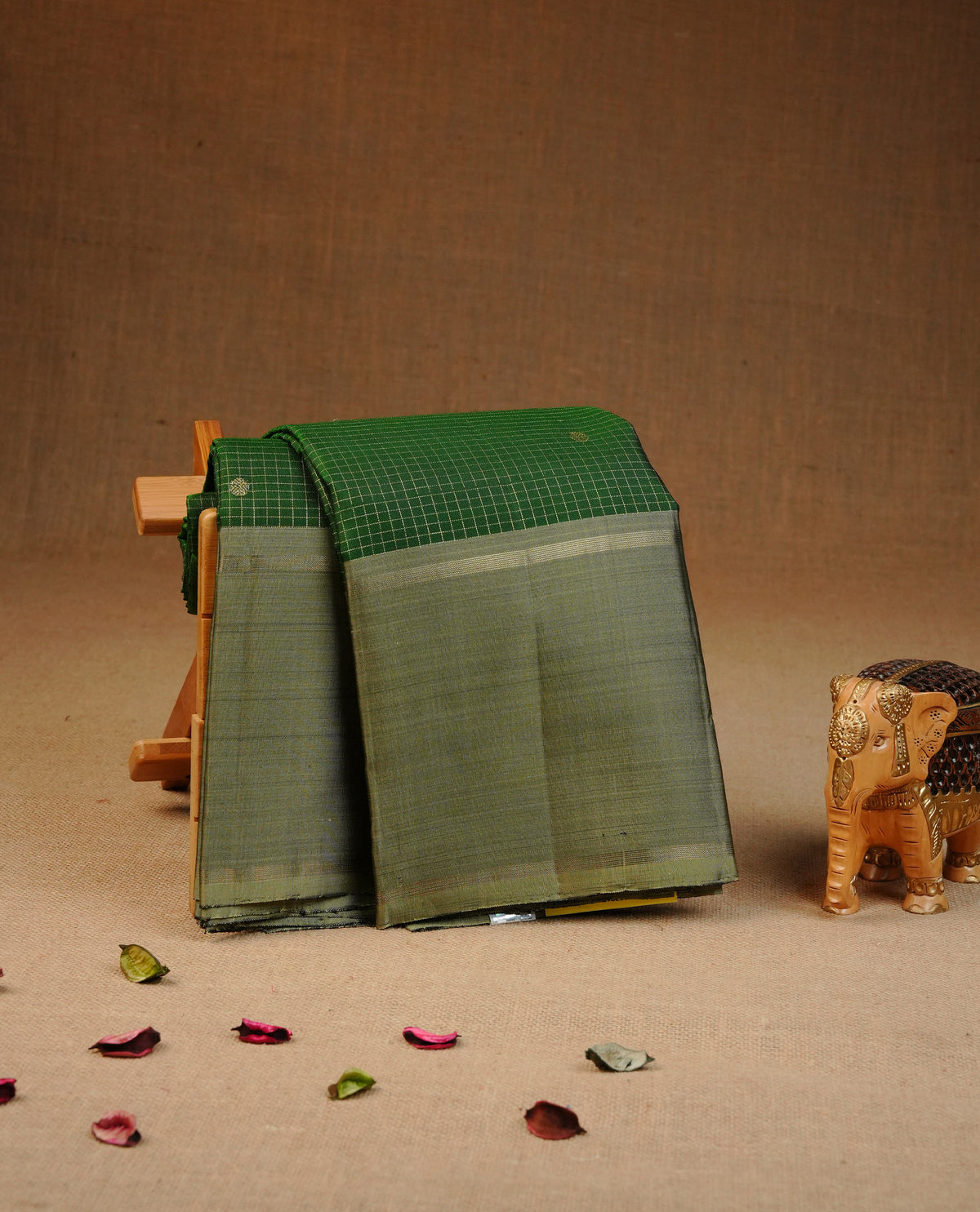 Green colour traditional kancheepuram silk saree featuring Gold zari tin check with motifs on body, complemented by contrast Olive with simple border, comes with matching blouse piece.