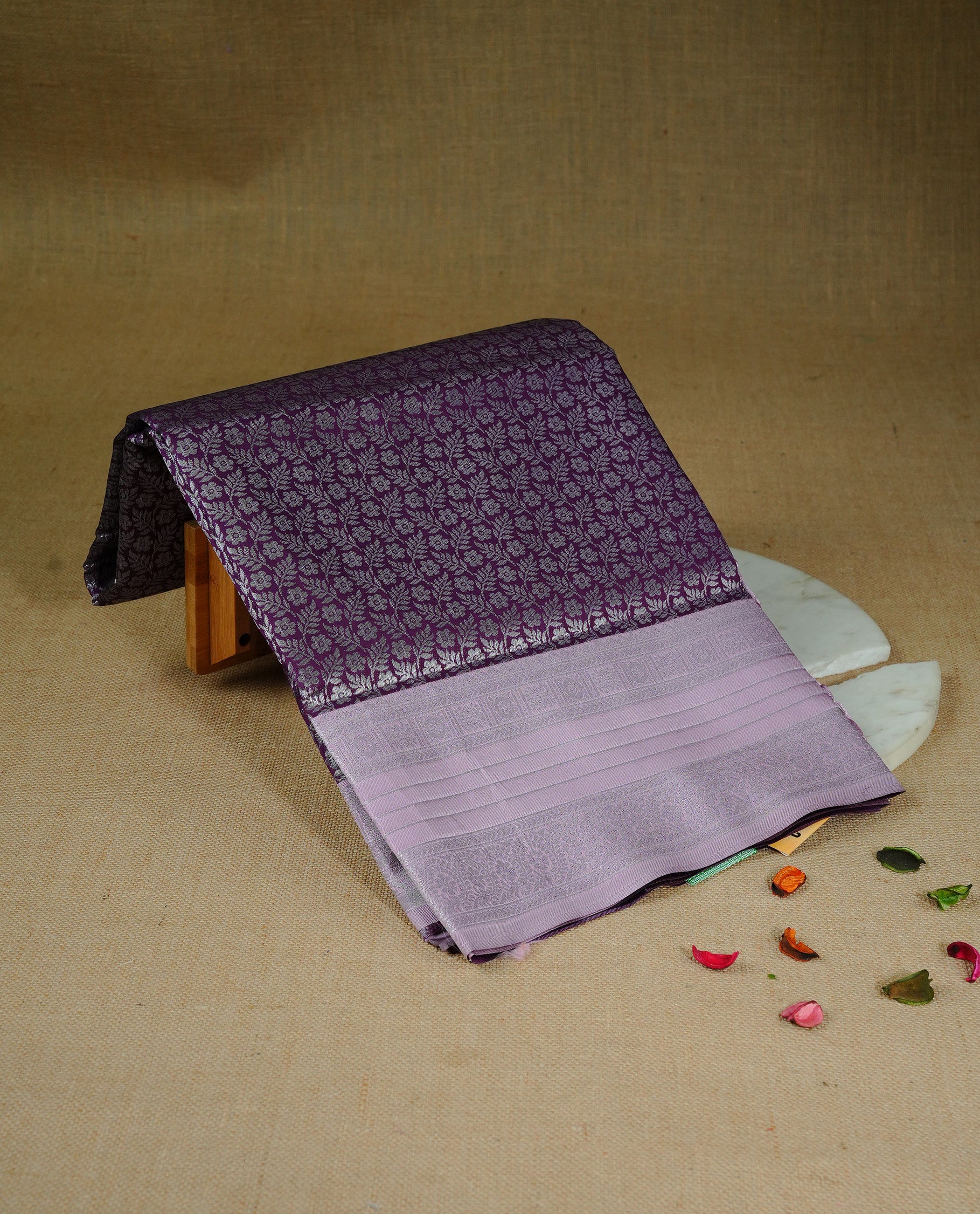 Purple colour semi silk saree featuring Silver zari Floral pattern on body, complemented by contrast Pink colour with silver zari border, comes with matching blouse piece.