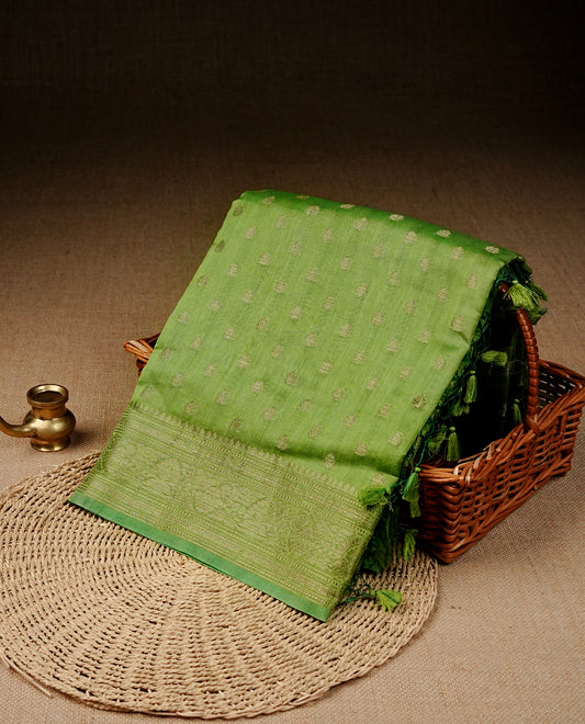 Pastel green colour banaras saree featuring Gold zari buttas on body, complemented by self colour with simple zari border, comes with matching blouse piece.