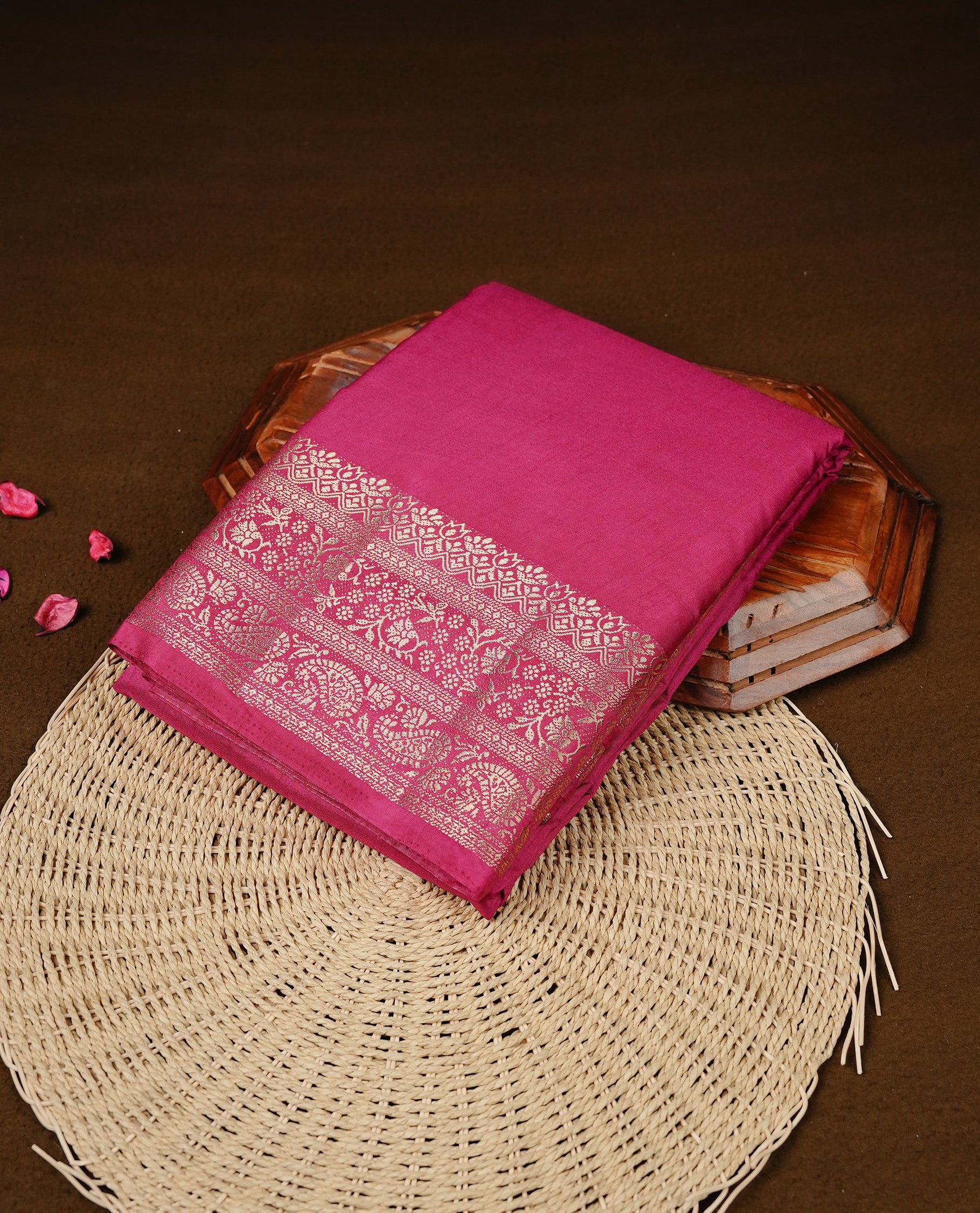 Pink colour Semi Tussar silk saree featuring an elegant plain body, accentuated by a self colour with gold traditional zari border, paired with a matching blouse piece.