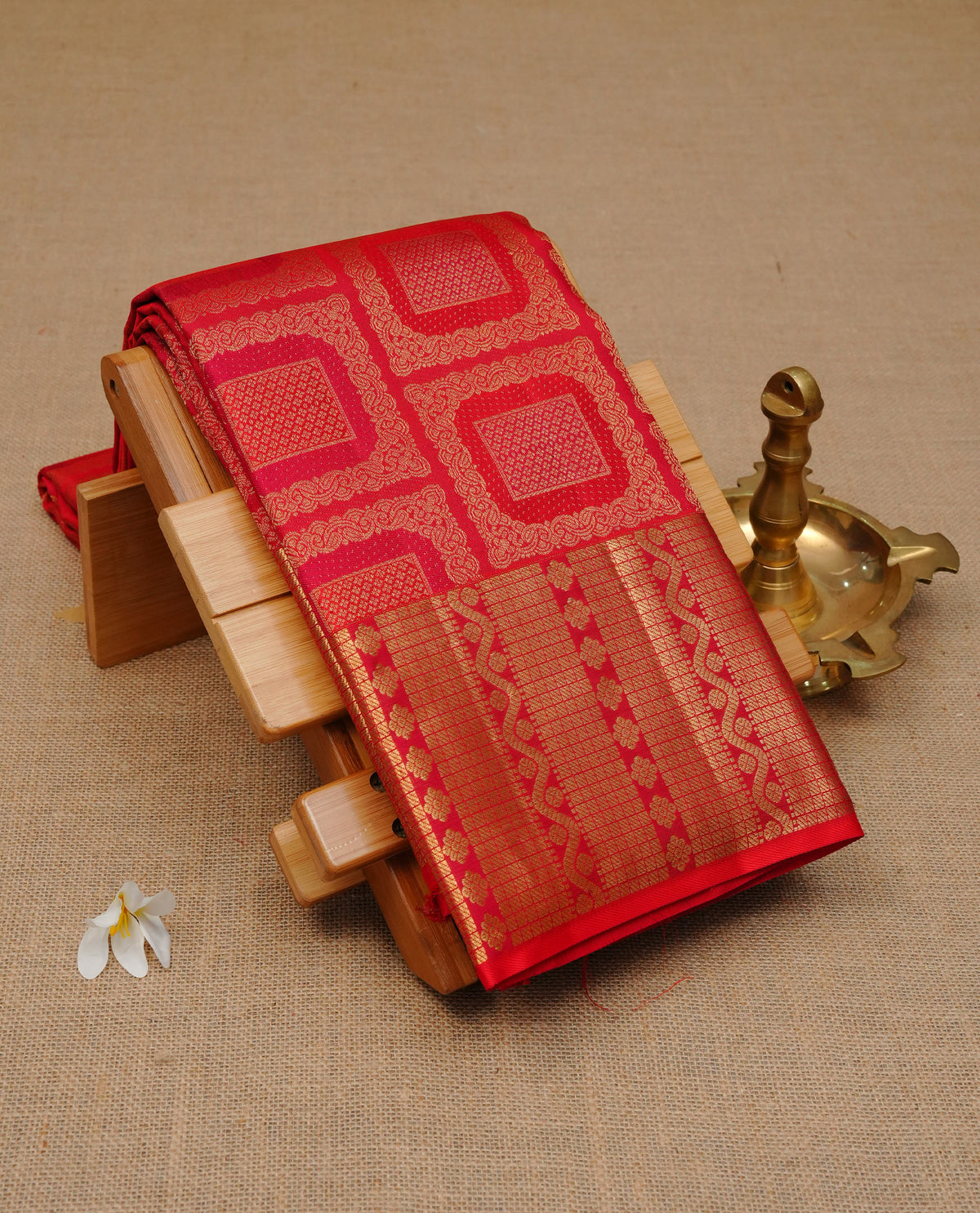 Red colour Pure Wedding silk saree featuring Gold zari box designed pattern on  body, complemented by self colour with traditional border, comes with matching blouse piece.