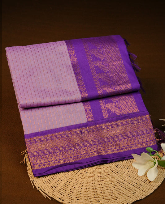 Lavender colour Kalyani cotton saree featuring Gold zari check pattern on body, complemented by Contrast Violet colour with grand gold zari border & pallu, matching blouse piece