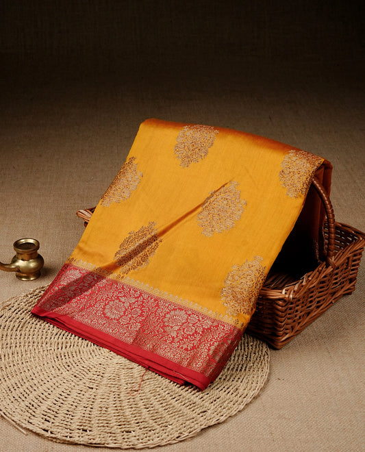Mustard colour banaras saree featuring gold zari motifs on body, complemented by contrast Maroon colour with gold zari border, comes with matching blouse piece.