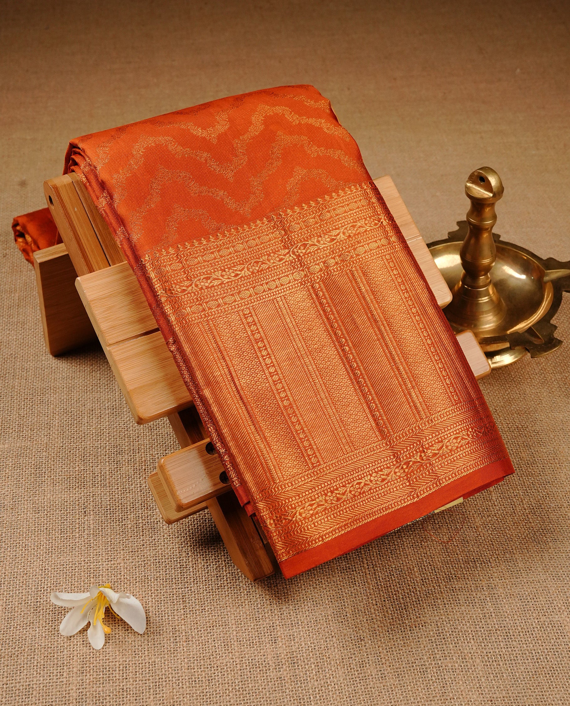 Coral Orange  Colour Pure Kancheepuram Silk Saree Featuring Gold Zari Zig Zag  Pattern on the Body, Highlighting a Traditional Gold Zari Border, Paired with a Matching Blouse Piece.