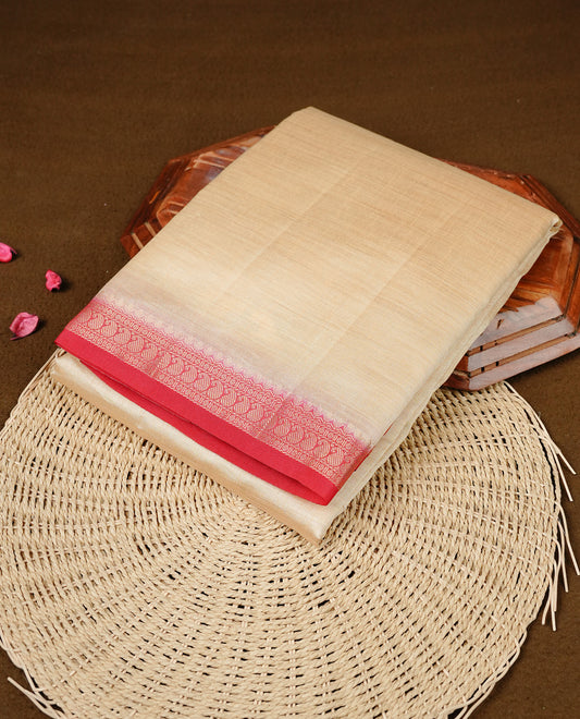 Cream colour Semi Tussar silk saree featuring an elegant plain body, accentuated by a contrast Red border adorned with intricate gold Mango zari work, paired with a matching blouse piece.