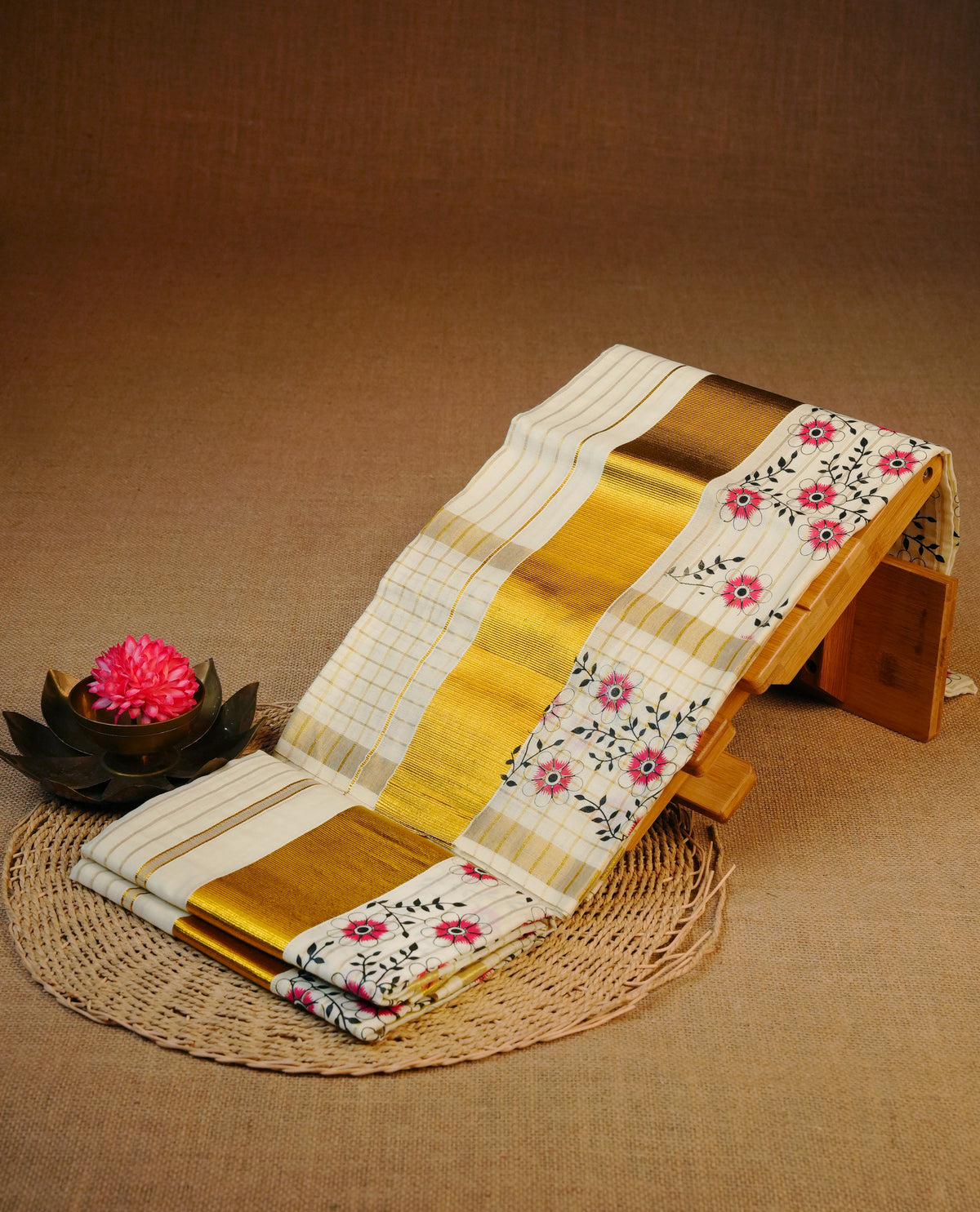 Cream colour cotton set mundu featuring Gold strips on body, gold kasav with red Floral print kara.