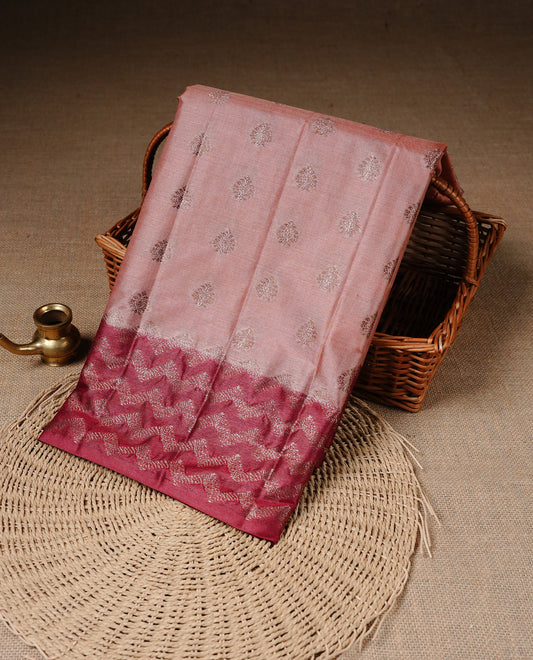 Peach Colour Tussar silk saree featuring Antique Zari motifs on body, Finished with contrast Maroon colour Zigzag zari pattern border, paired with matching blouse piece.