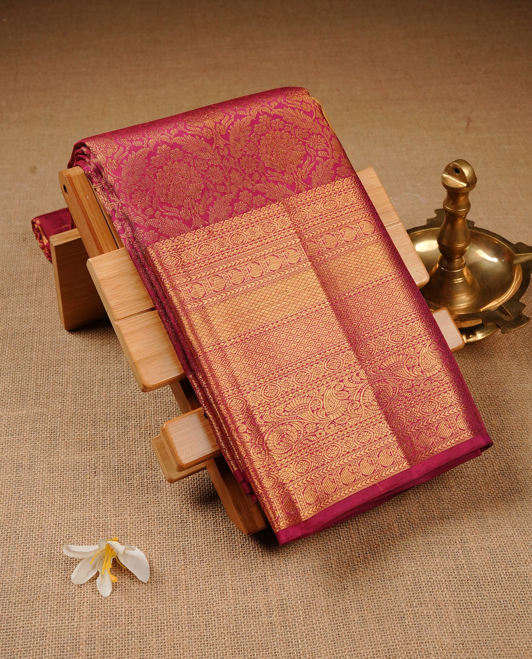Magenta Colour Pure Kancheepuram Silk Saree Featuring Gold Zari Floral Kodi Pattern on the Body, Highlighting a Traditional Gold Zari Border, Paired with a Matching Blouse Piece.