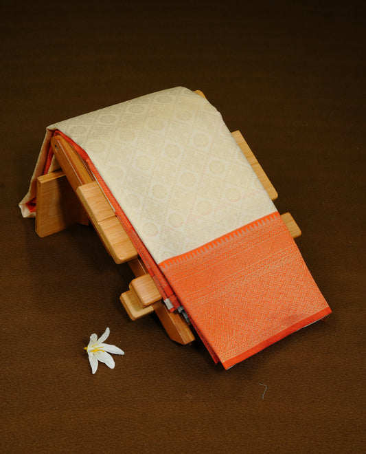Cream Colour Semi Soft Silk Saree Featuring Gold zari Box With motifs Pattern On Body, Highlighted  by contrast Orange border with Gold zari, paired with matching blouse piece.