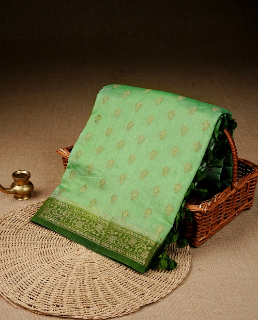 Pista green colour banaras silk saree featuring gold zari buttas on body, complemented by contrast Dark green with gold zari border, comes with matching blouse piece.