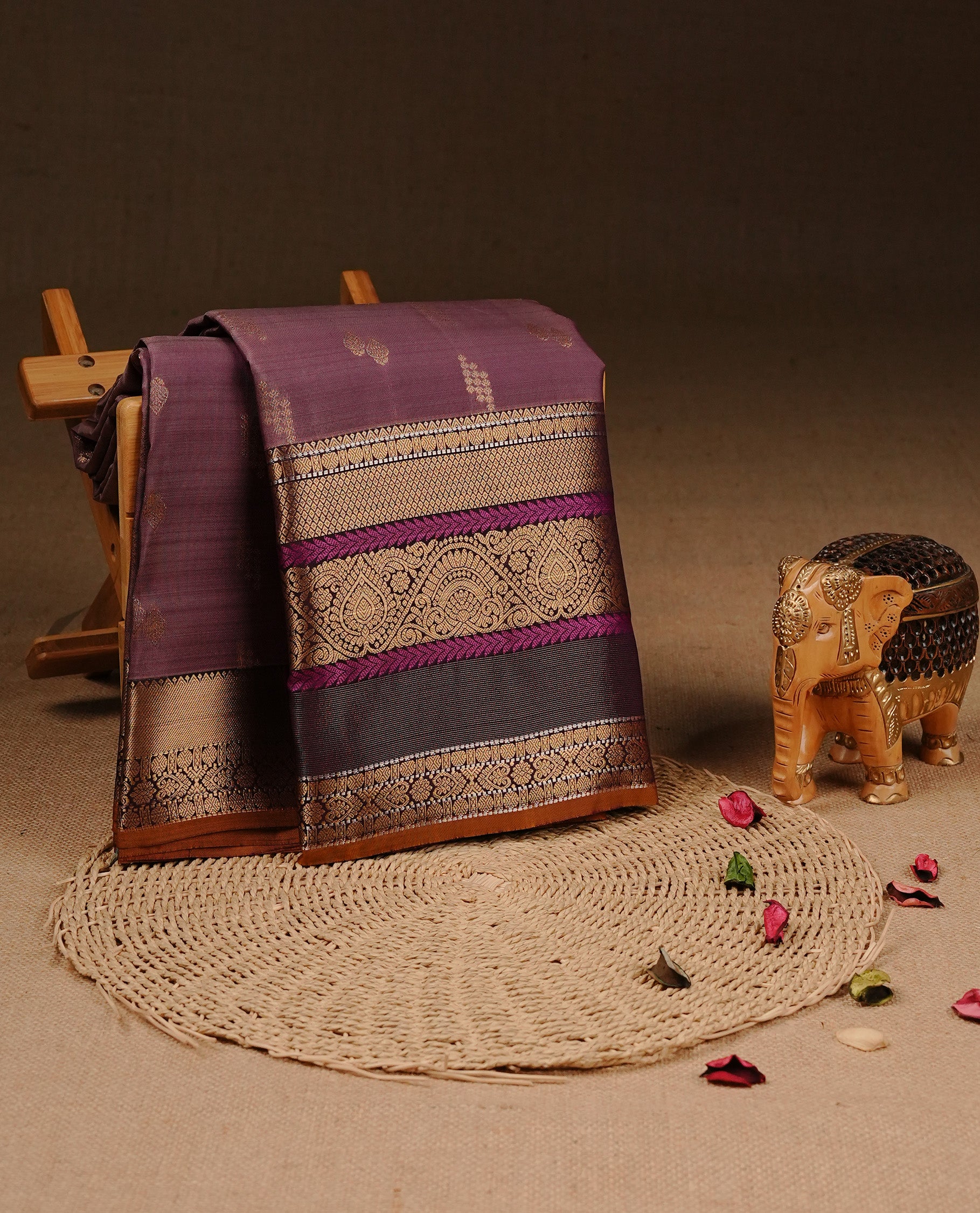 Purple Colour Traditional Kancheepuram Silk Saree Featuring Gold Zari Motifs on Body, Complemented By Self colour with Traditional zari & purple border, paired with matching blouse piece.