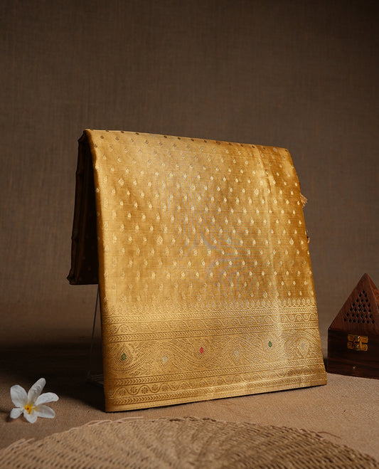 Yellow Gold colour tissue banaras silk saree featuring antique gold zari motifs on the body with rich traditional zari border and pallu, paired with a matching blouse piece.