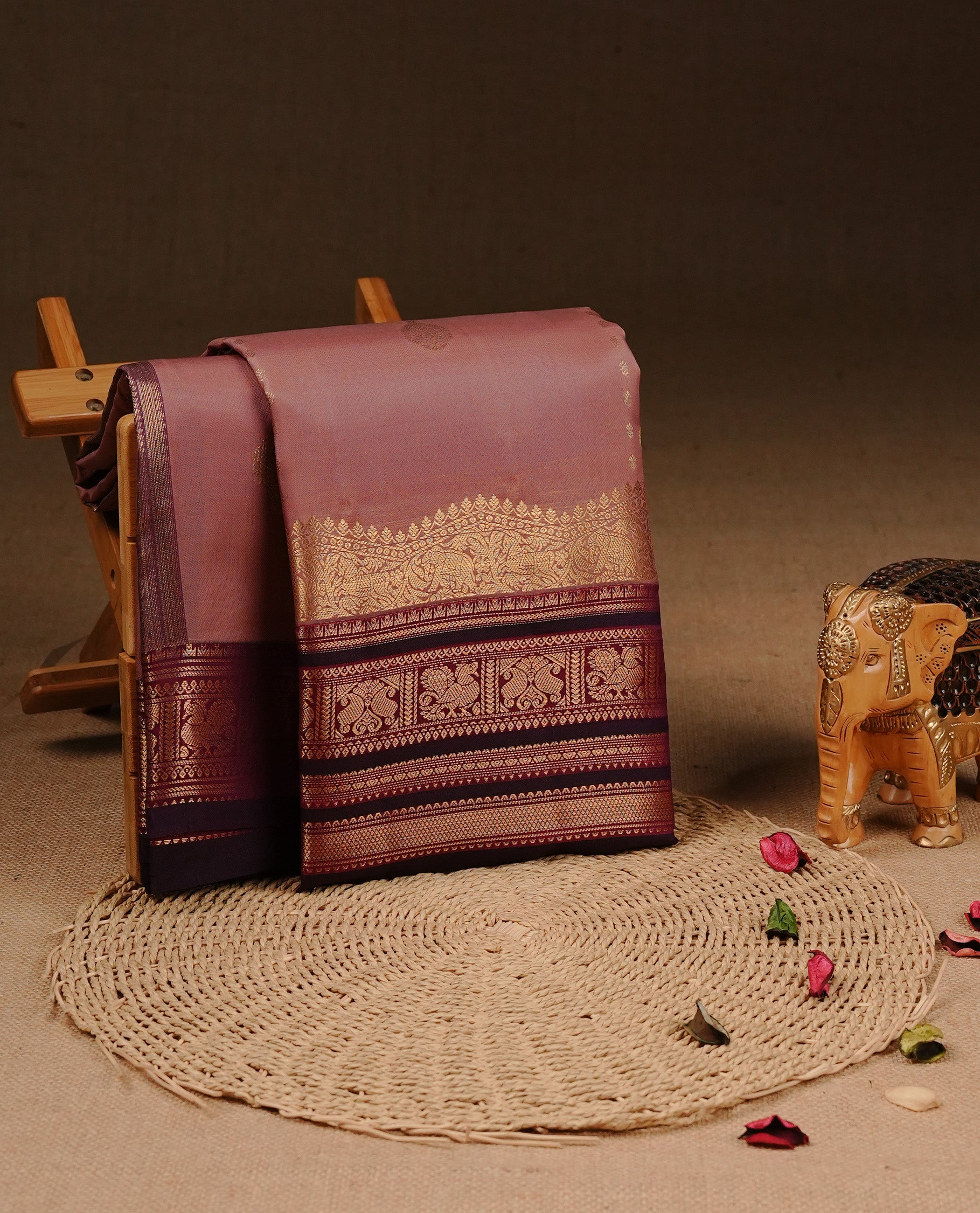 Mauve colour Traditional Kancheepuram silk saree featuring gold zari motifs on body, enhanced with contrast Purple with traditional border, paired with matching blouse piece.