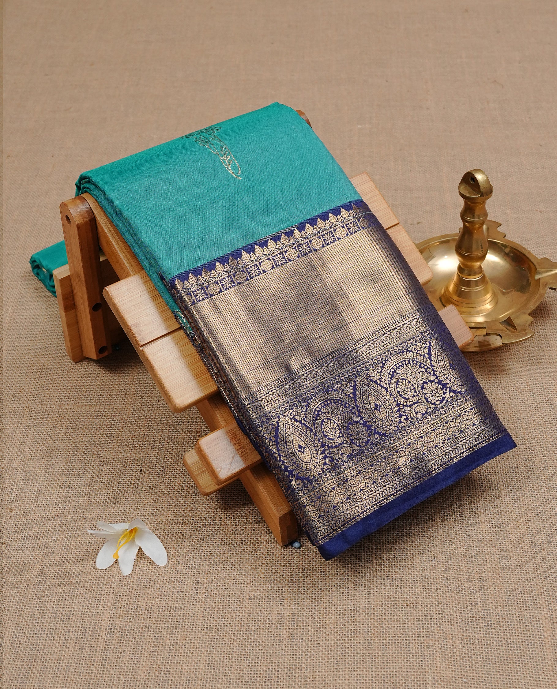 Aqua colour semi Wedding silk saree featuring Gold zari motifs on body, enhanced with Contrast Blue colour with traditional border, paired with matching blouse piece.