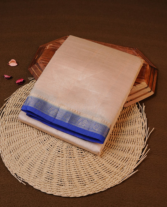 Cream colour Tussar silk saree Featuring Elegant Plain body, complemented by Contrast Blue colour with gold zari border, paired with matching blouse piece.