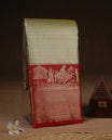 Gold colour Semi Tissue silk saree featuring silver zari pattern on body, complemented by traditional border with contrast Red colour, paired with matching blouse piece.