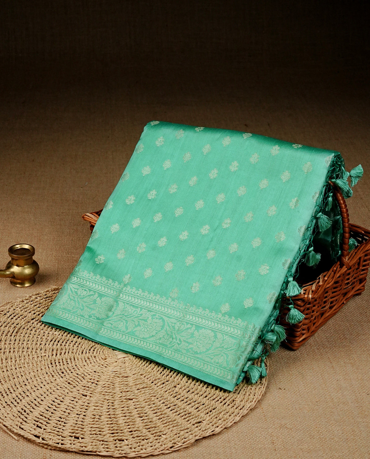 pastel green colour banaras saree featuring silver zari buttas on body, complemented silver zari on self colour border, comes with matching blouse piece.