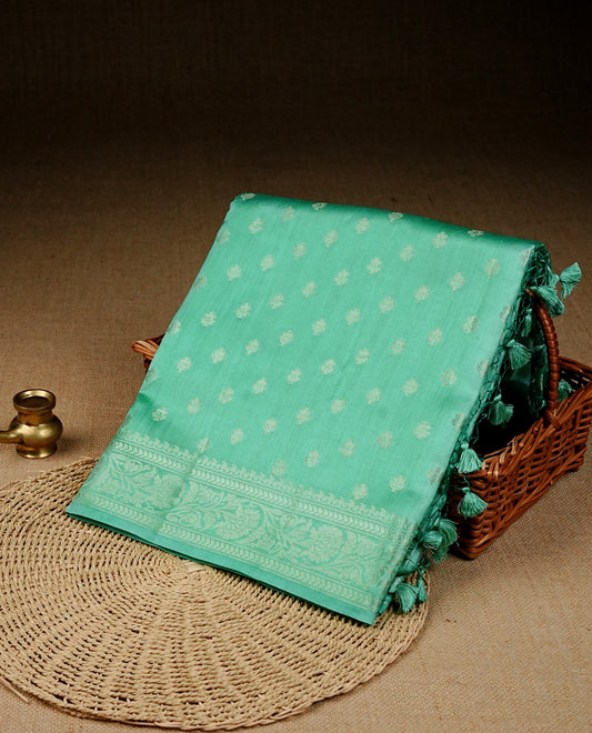 pastel green colour banaras saree featuring silver zari buttas on body, complemented silver zari on self colour border, comes with matching blouse piece.