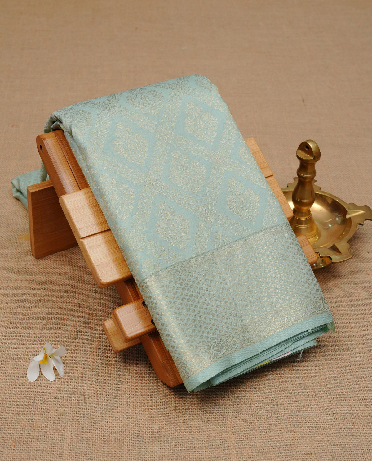 Ice blue colour Pure wedding silk saree featuring Light gold Box pattern with motifs on body, complemented by self colour with traditional border, comes with matching blouse piece.