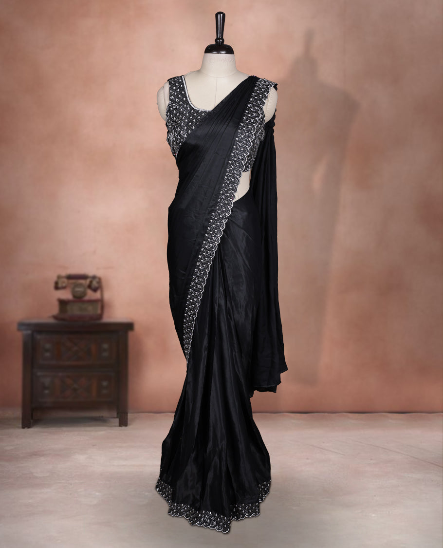 Elegant Black colour ready to wear saree adorned with rich white stone embroidery along the border and pallu, paired with a heavily embellished matching blouse for a grand festive look.