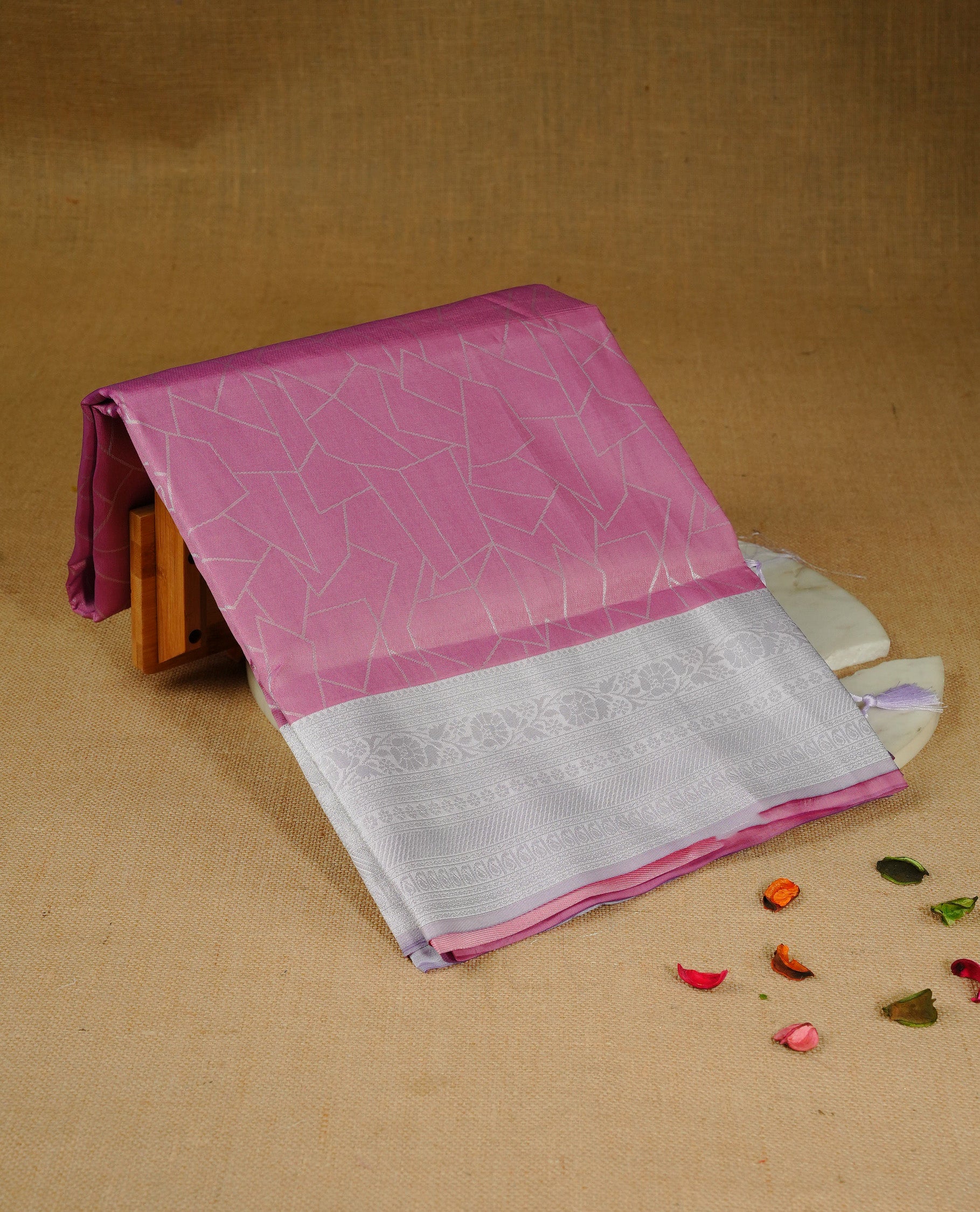 Pink colour semi silk saree featuring Silver zari Geometric pattern on body, complemented by contrast Lavender colour with silver zari border, comes with matching blouse piece.