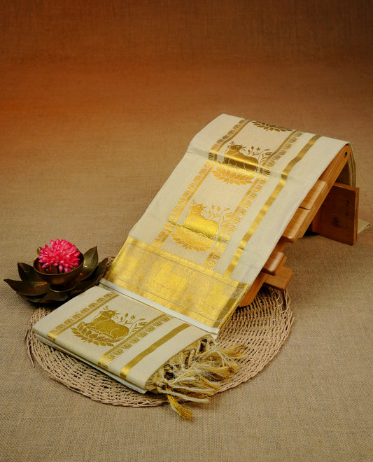Cream Colour tissue set mundu featuring a plain body, enhanced with elegant Cow Design on the gold zari kara.