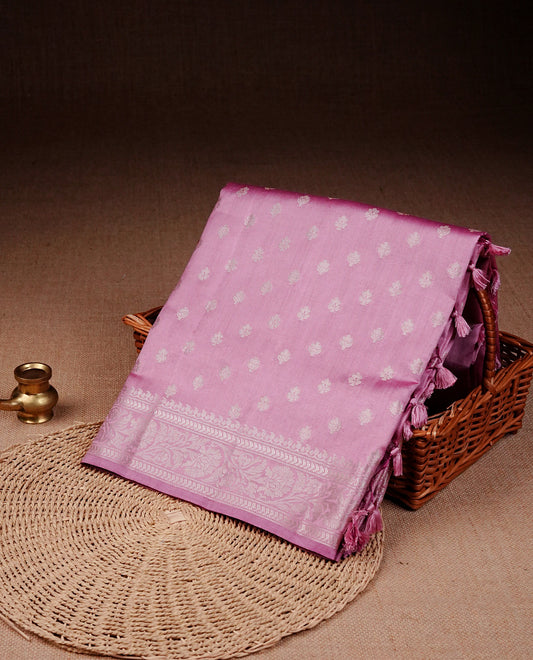 Light pink colour banaras saree featuring silver zari buttas on body, complemented silver zari on self colour border, comes with matching blouse piece.
