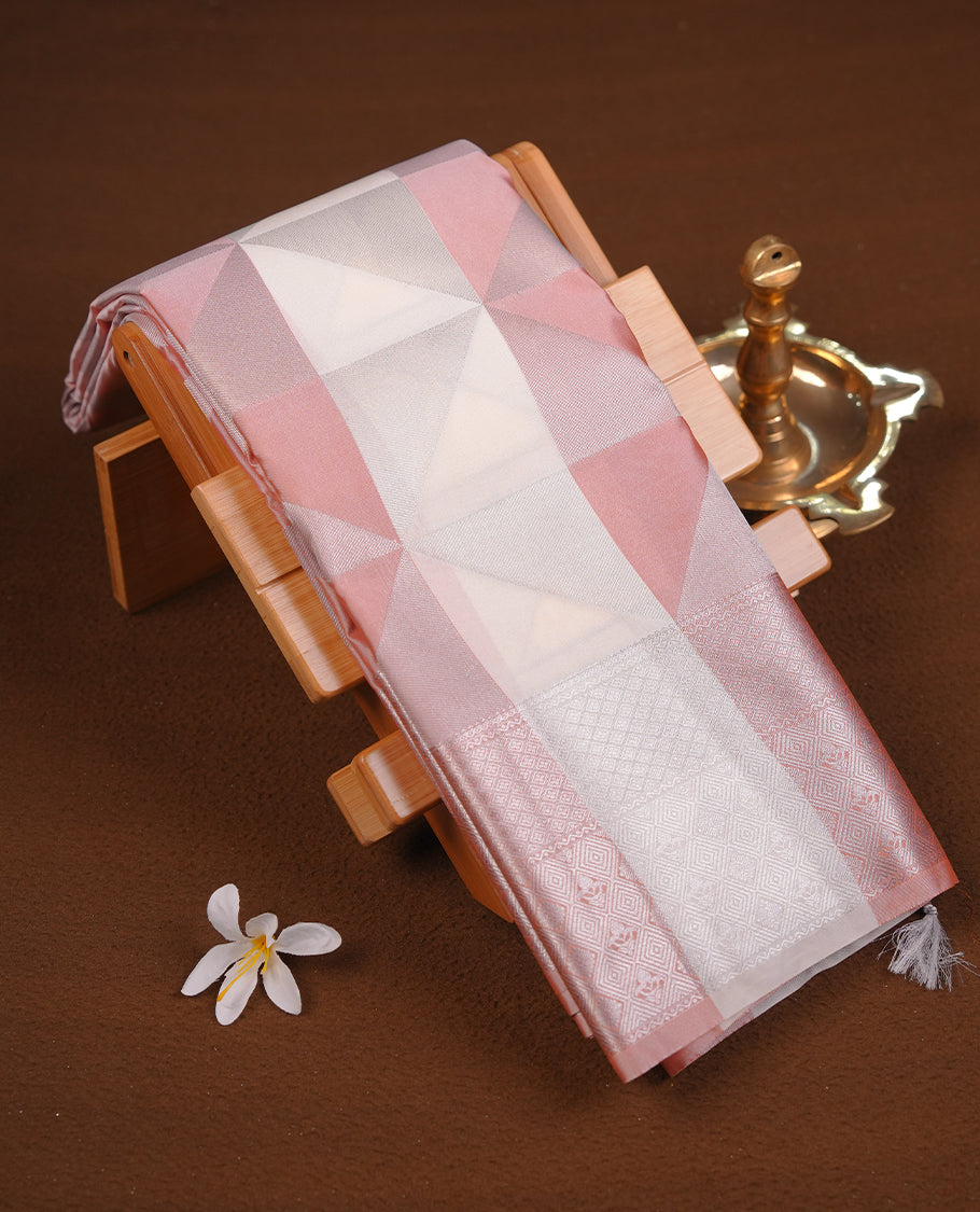 Peach & cream colour semi soft silk saree featuring a silver zari patterned body, complemented by silver zari motifes on pallu & border and a matching blouse piece.