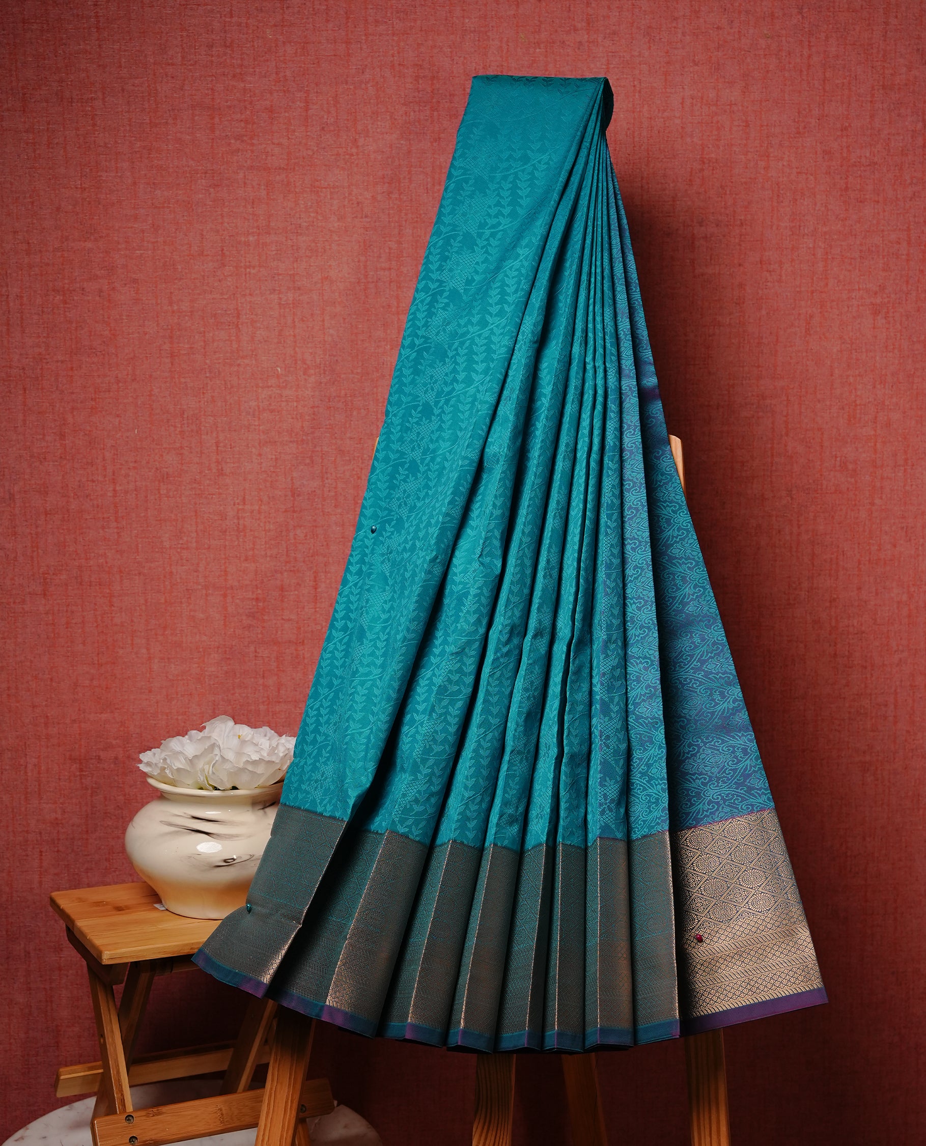 Green colour Semi silk saree Featuring Self colour zari motifs on body, complemented by contrast purple colour with gold zari border, paired with matching blouse piece.